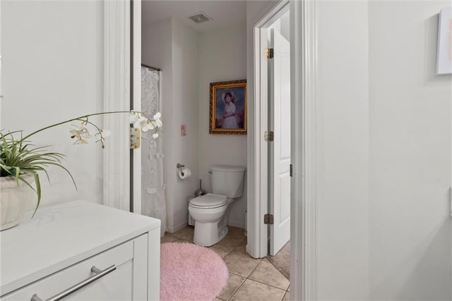 bathroom with vanity, tile patterned flooring, and toilet