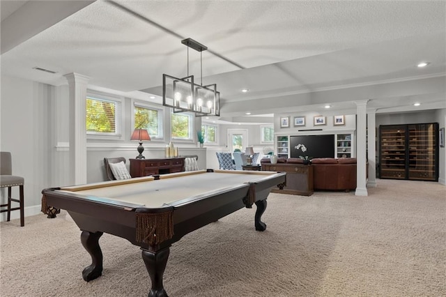 rec room with pool table, light colored carpet, a textured ceiling, and ornate columns