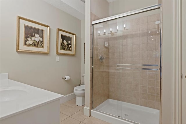 bathroom featuring vanity, walk in shower, tile patterned flooring, and toilet