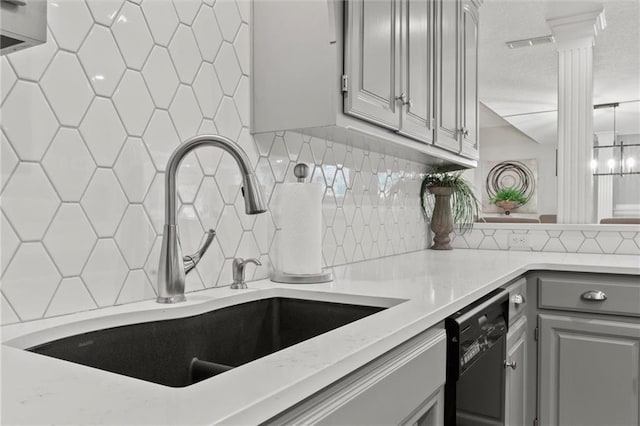 kitchen with black dishwasher, gray cabinets, sink, and backsplash