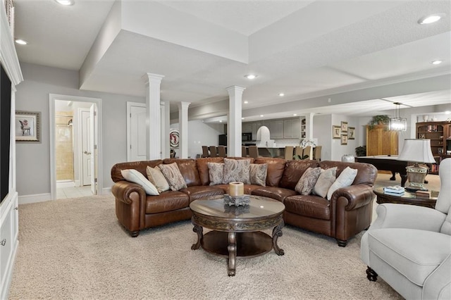 living room with light carpet and ornate columns