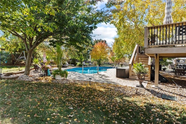 view of pool featuring a wooden deck and a patio area