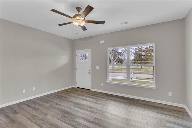 foyer with ceiling fan and light wood-type flooring