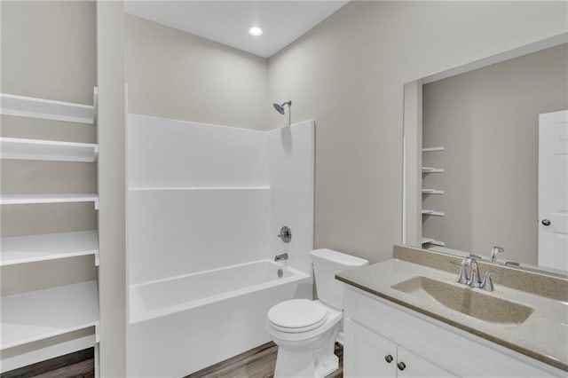 full bathroom with hardwood / wood-style flooring, vanity, toilet, and bathing tub / shower combination