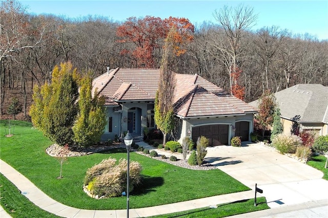 view of front of house with a front yard and a garage