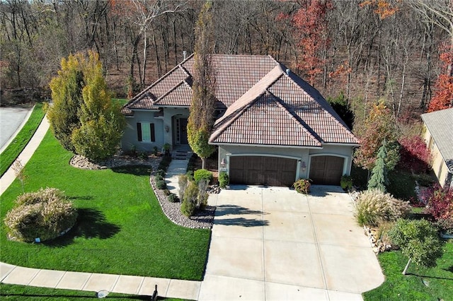 view of front of house with a garage and a front lawn