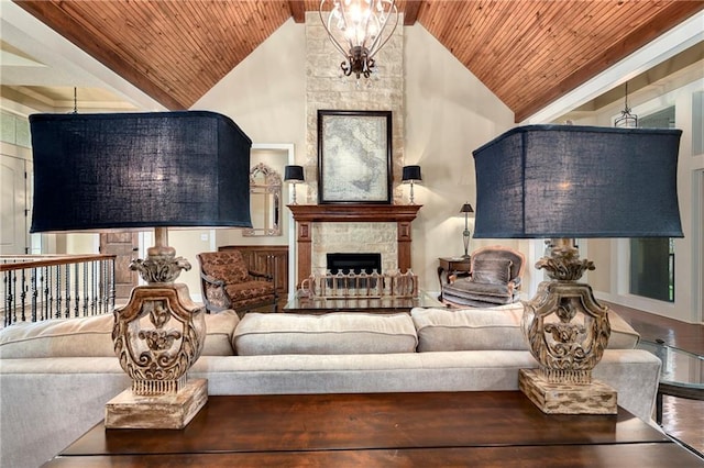 living room featuring high vaulted ceiling, a stone fireplace, and wood ceiling