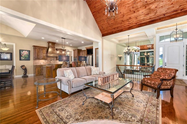 living room featuring dark hardwood / wood-style flooring, wooden ceiling, high vaulted ceiling, and a chandelier