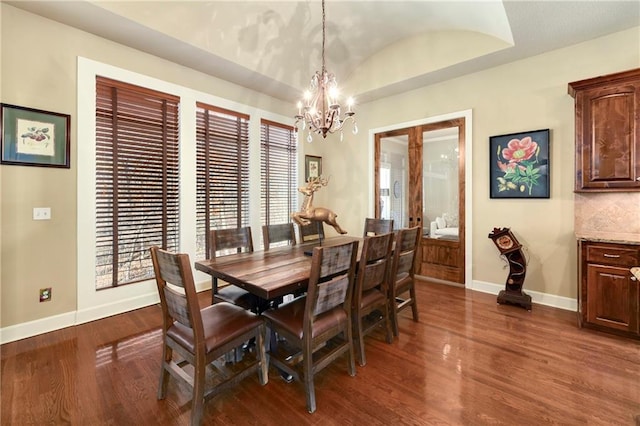 dining room featuring a chandelier and dark wood-type flooring