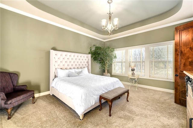 bedroom featuring light carpet, ornamental molding, a raised ceiling, and a notable chandelier