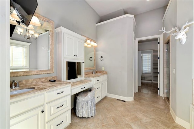 bathroom with vanity and lofted ceiling