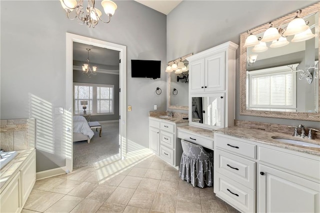 bathroom with plenty of natural light, vanity, and a chandelier