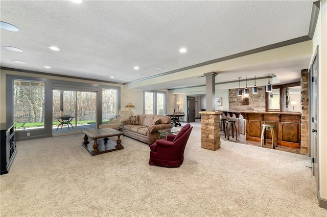 living room featuring crown molding, carpet floors, and a textured ceiling