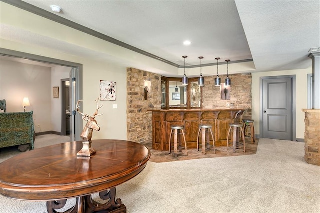 bar featuring a textured ceiling, carpet floors, and decorative light fixtures