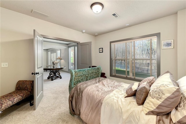 carpeted bedroom featuring a textured ceiling