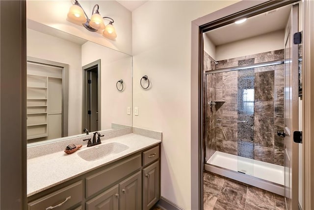 bathroom with vanity and a shower with door