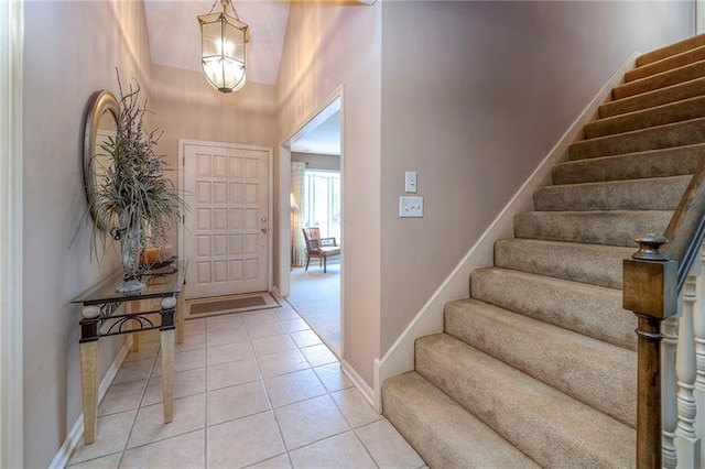 entrance foyer featuring a high ceiling and light tile patterned flooring