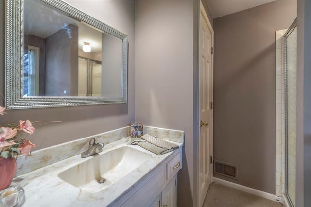 bathroom with walk in shower and vanity