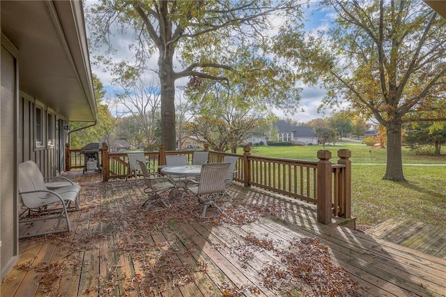 wooden terrace featuring a lawn