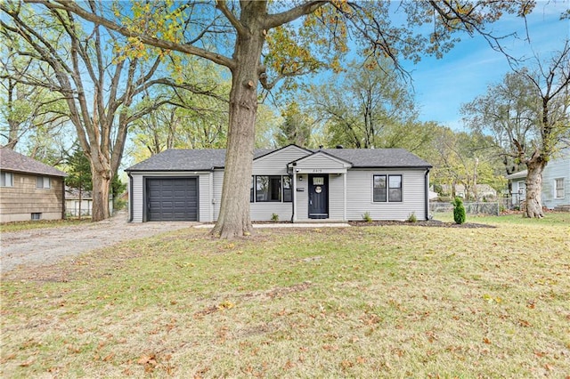 single story home featuring a front yard and a garage