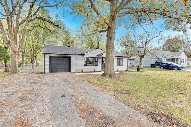 ranch-style house featuring a garage and a front yard