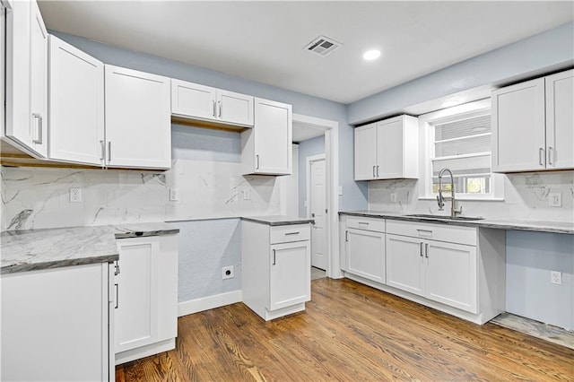 kitchen featuring sink, white cabinets, and dark hardwood / wood-style floors