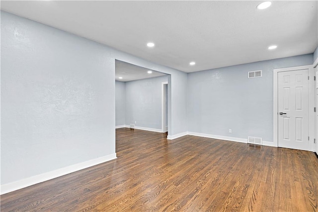 unfurnished room featuring dark wood-type flooring