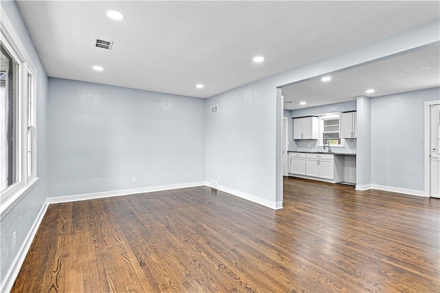 unfurnished living room featuring dark wood-type flooring