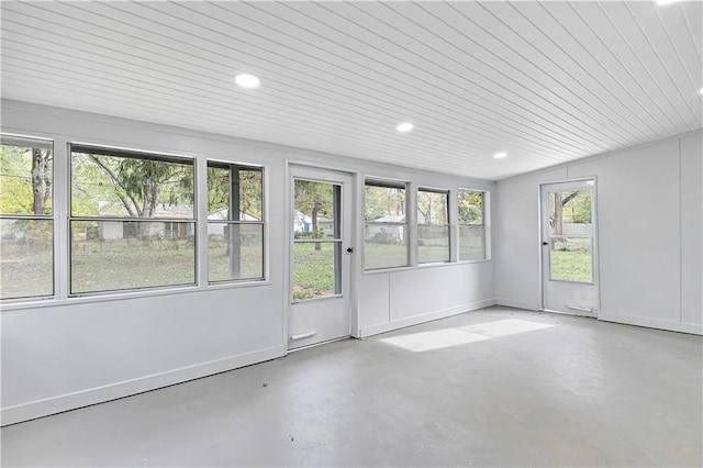 unfurnished sunroom with plenty of natural light and wooden ceiling