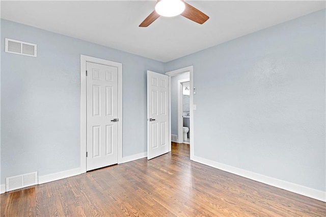 unfurnished bedroom with ceiling fan and dark hardwood / wood-style flooring