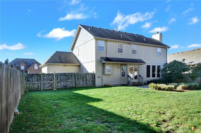 back of house with a yard and french doors