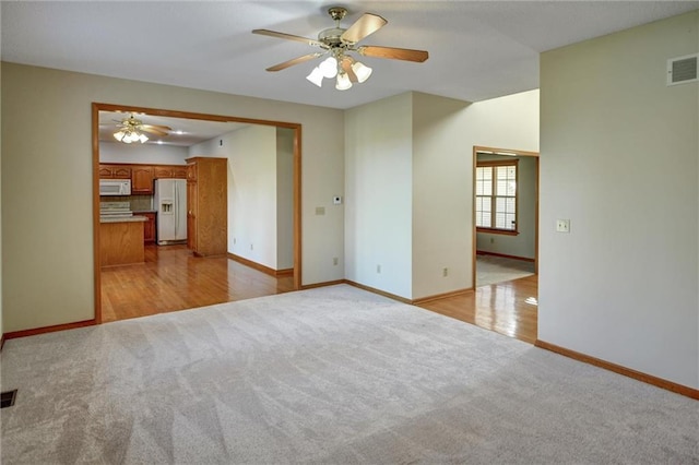 empty room featuring light wood-type flooring and ceiling fan