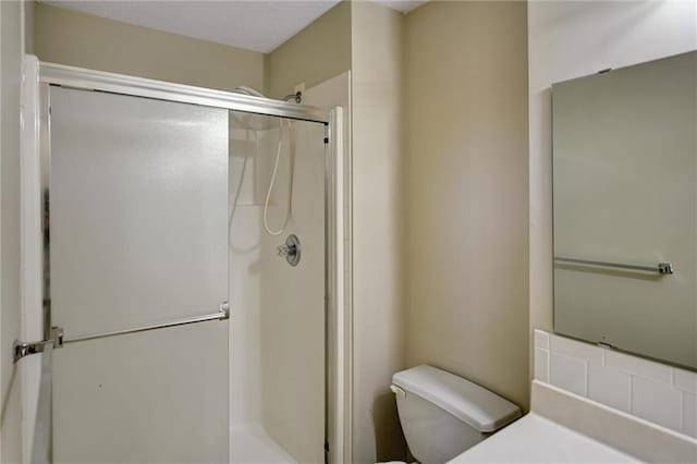 bathroom featuring toilet and walk in shower