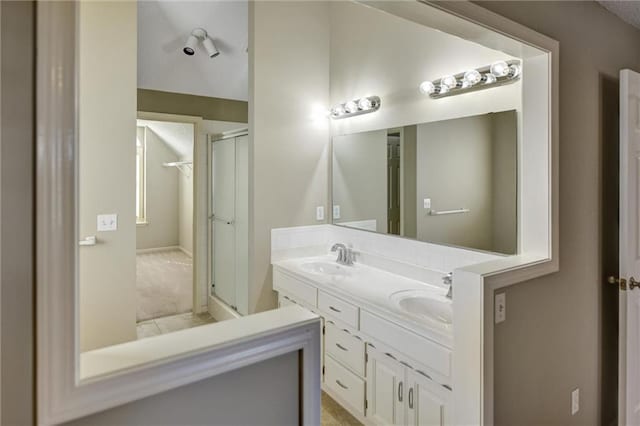 bathroom featuring vanity and an enclosed shower