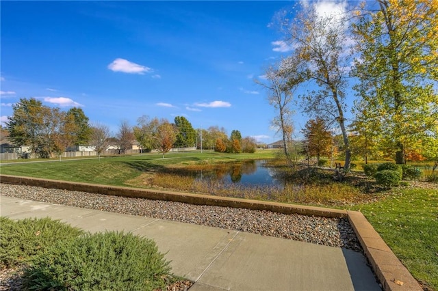 view of home's community featuring a water view and a yard