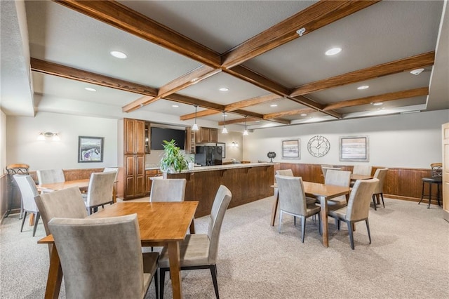 carpeted dining area featuring wooden walls, beamed ceiling, and coffered ceiling