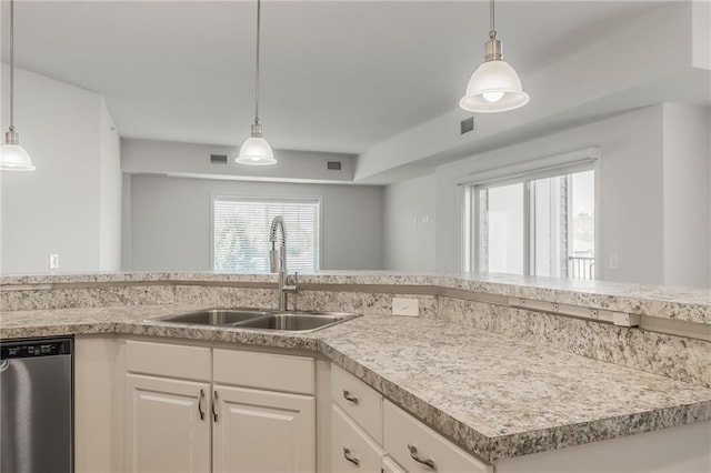 kitchen featuring white cabinetry, sink, pendant lighting, and dishwasher