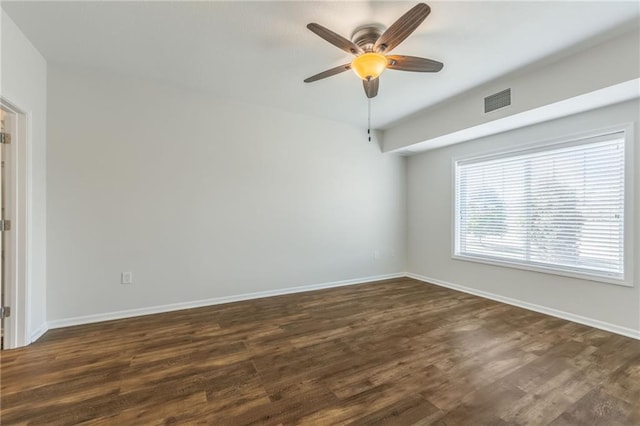 unfurnished room with dark wood-type flooring and ceiling fan