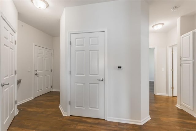 hallway with dark wood-type flooring