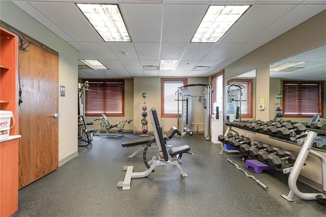 exercise room with a paneled ceiling