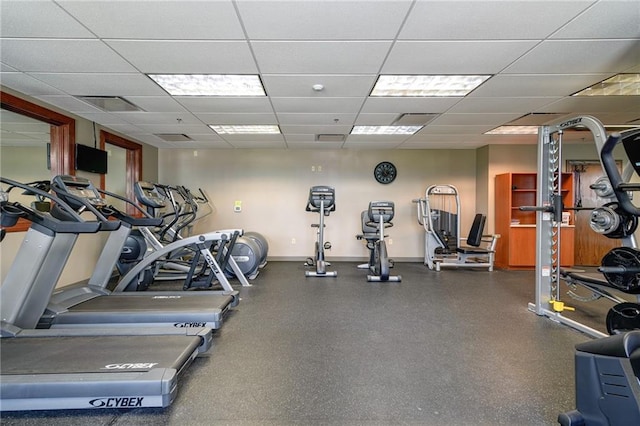 gym featuring a paneled ceiling