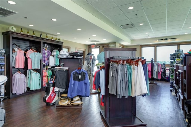 spacious closet featuring dark wood-type flooring and a paneled ceiling