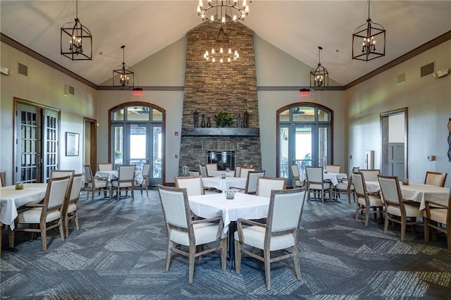 carpeted dining space with french doors, a wealth of natural light, and high vaulted ceiling