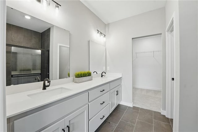1024 Branchwood Ln, Raymore, MO 64083 - bathroom featuring double vanity, a stall shower, and a walk in closet