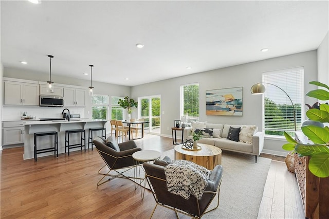 1024 Branchwood Ln, Raymore, MO 64083 - living area with light wood finished floors and recessed lighting