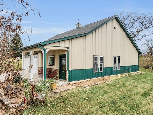 view of home's exterior with a lawn and a garage