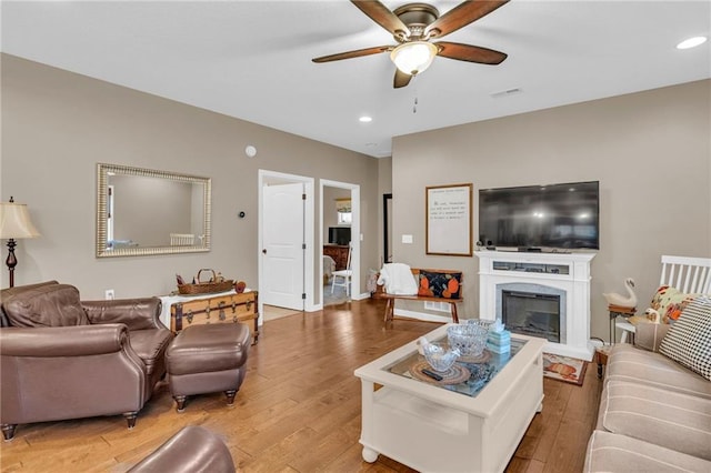 living room with hardwood / wood-style flooring and ceiling fan