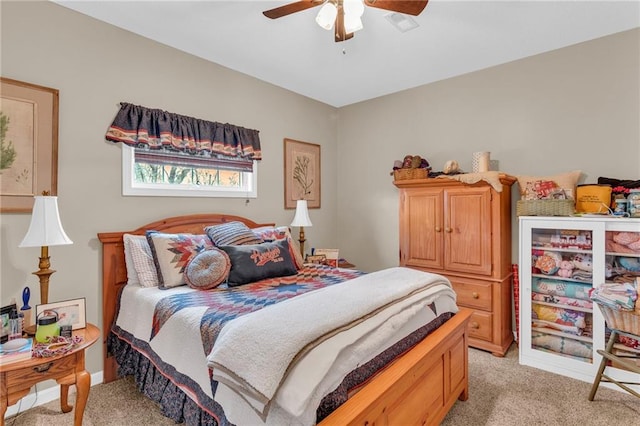 bedroom with ceiling fan and light colored carpet