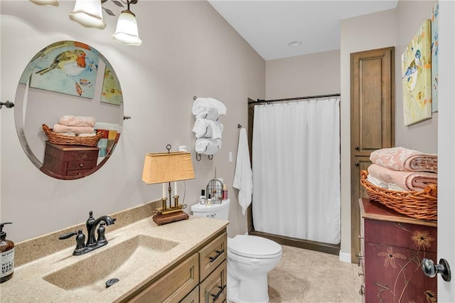 bathroom featuring walk in shower, vanity, and toilet