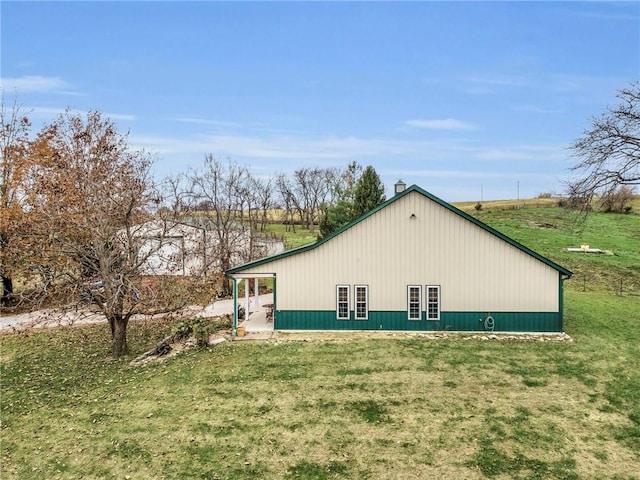 view of side of home featuring a lawn